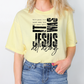 A woman wearing a yellow t-shirt with a graphic design featuring text and a Bible verse.