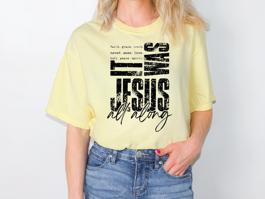 A woman wearing a yellow t-shirt with a graphic design featuring text and a Bible verse.