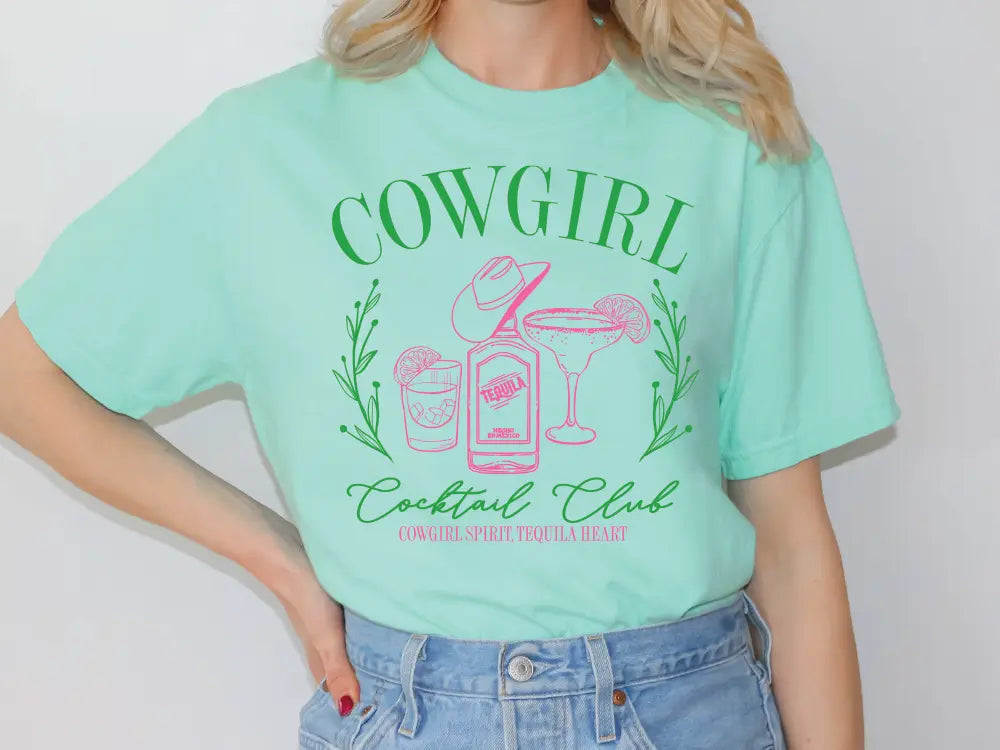 a woman wearing a green cowgirl tee shirt