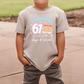 A child wearing a t-shirt with the text "I SURVIVED 67+63 days of school" printed on it.