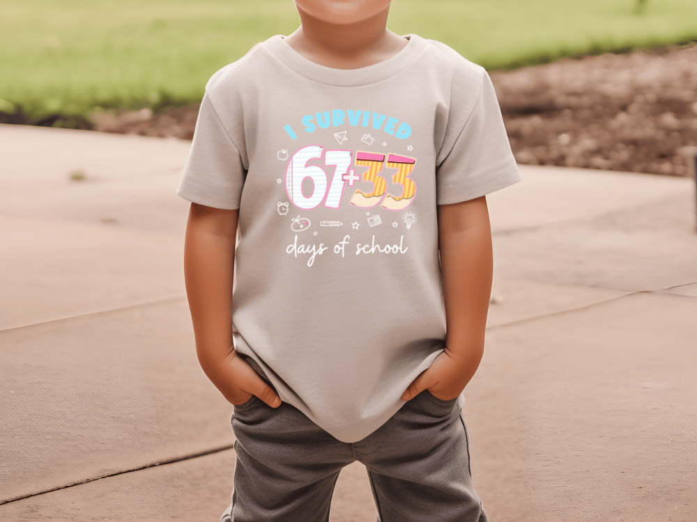 A child wearing a t-shirt with the text "I SURVIVED 67+63 days of school" printed on it.