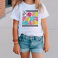 a little girl standing on a sidewalk wearing a t - shirt that says out fourth