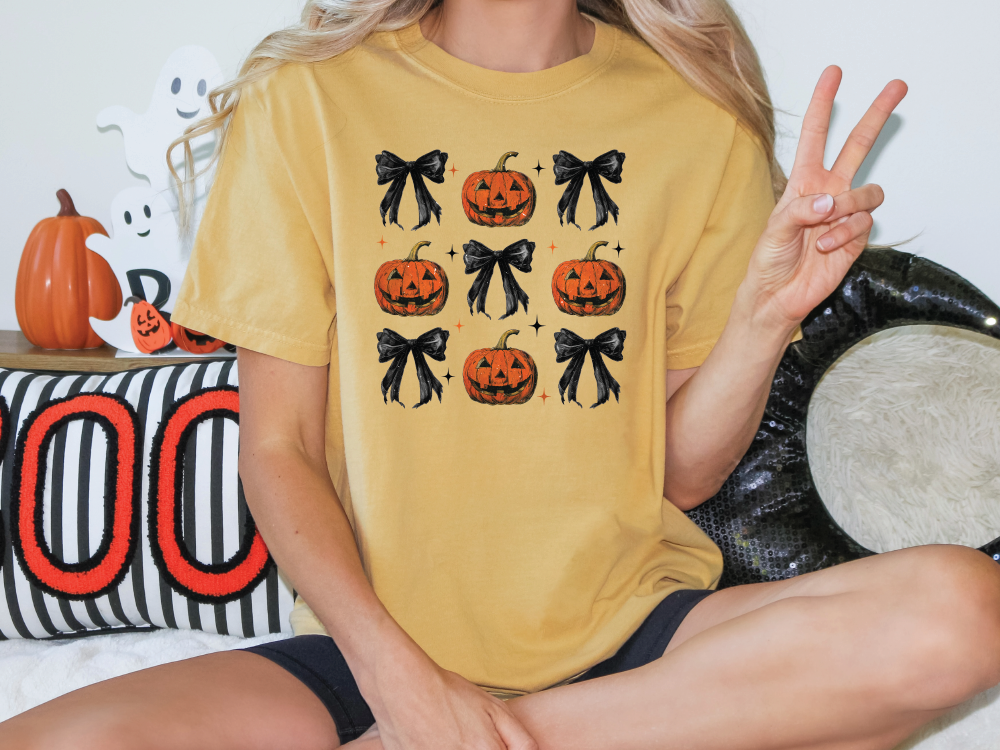 a woman sitting on a bed holding up a peace sign