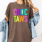 A person wearing a brown t-shirt with the text "CHOC TAWS" in a colorful, rainbow-colored font.