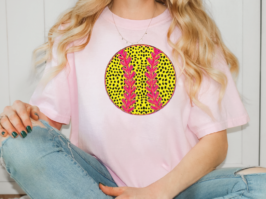 a woman sitting on the floor wearing a pink shirt and jeans