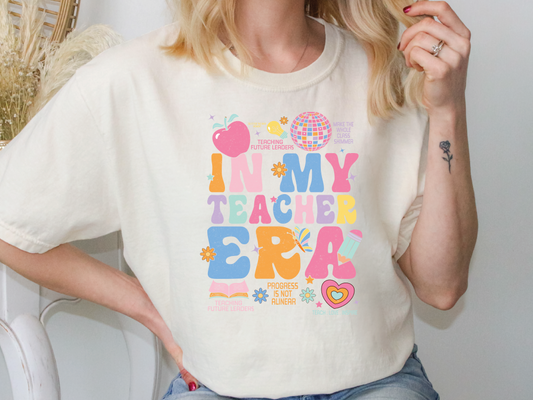 a woman wearing a t - shirt that says i'm my teacher era