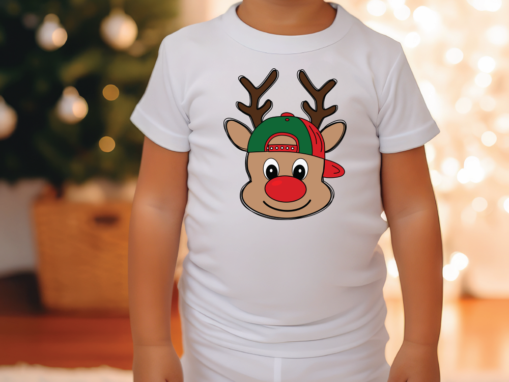 a little boy wearing a white shirt with a reindeer head on it