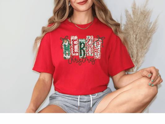 A woman wearing a red t-shirt with the text "MERRY CHRISTMAS" is sitting with her legs crossed, smiling at the camera.