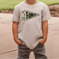 A child wearing a white t-shirt with a graphic of a flag and the word "Eagles" printed on it.