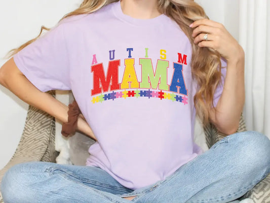 a woman sitting on a bed wearing a purple shirt