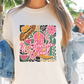 a woman wearing a t - shirt with a picture of a woman holding a cell