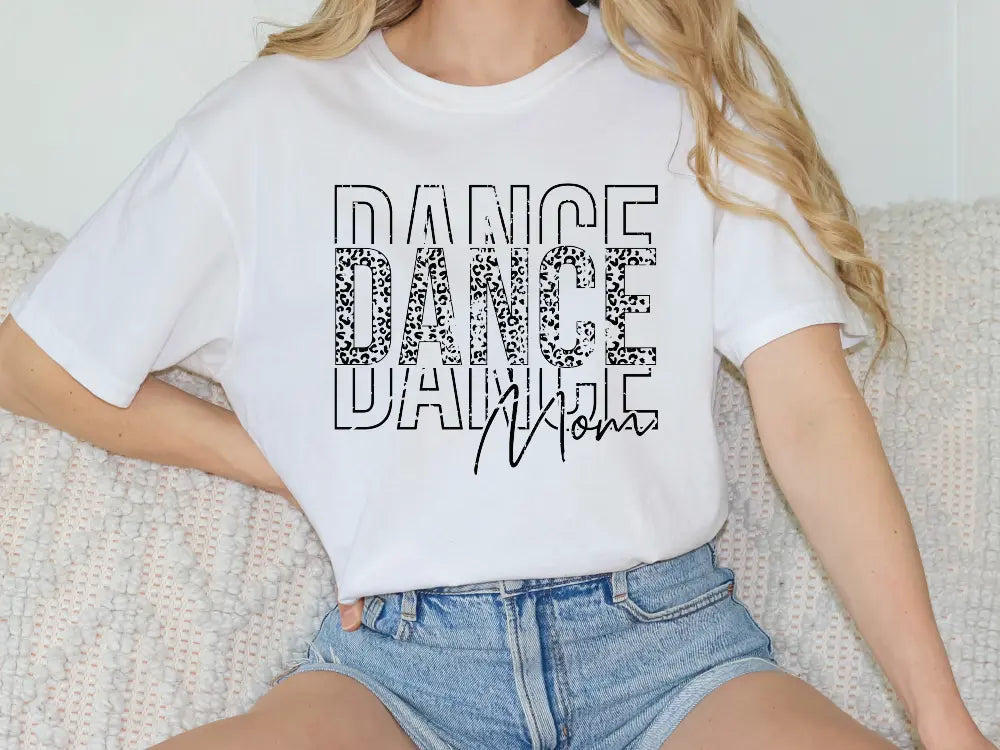 a woman sitting on a couch wearing a t - shirt that says dance dance dance