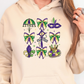 a woman wearing a hoodie with mardi gras decorations on it