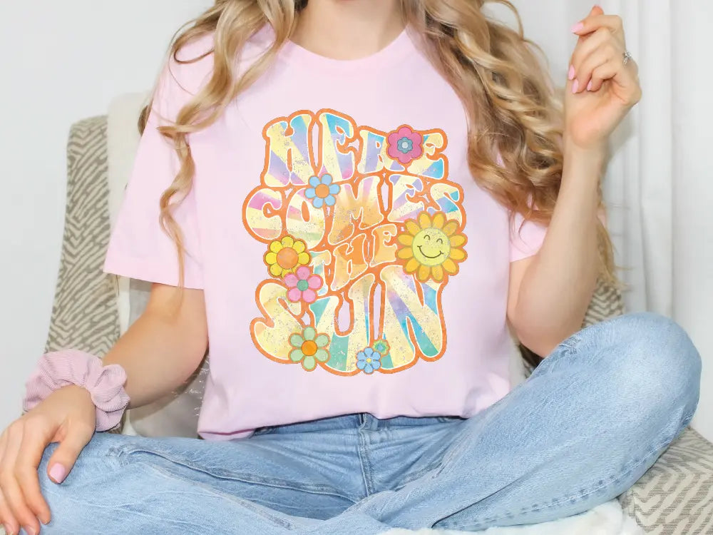 a woman sitting on a couch wearing a pink shirt