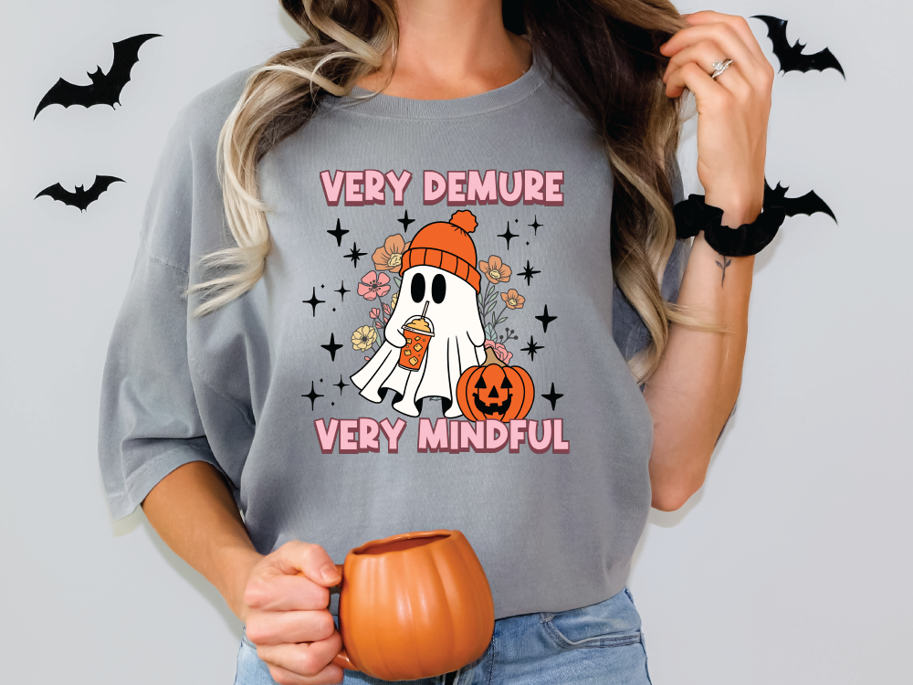 a woman wearing a very demure very mindful halloween t - shirt