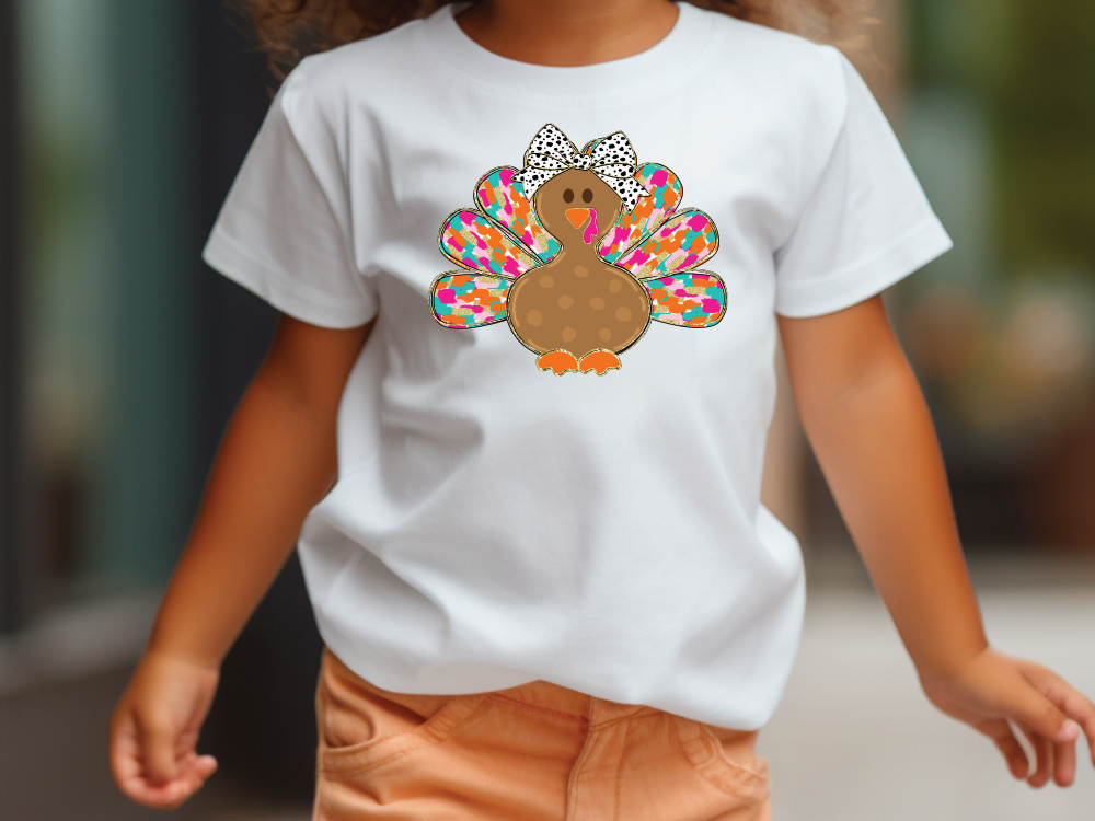 a little girl walking down a street wearing a turkey t - shirt