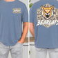 a man wearing a blue t-shirt with a camouflage pattern and a graphic of a fierce-looking cat, which appears to be a bear. The t-shirt has a text on the back that says "BEARCATS".