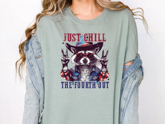 a woman wearing a t - shirt with a raccoon wearing a cowboy hat