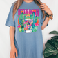 a woman wearing a blue t - shirt with a cactus print