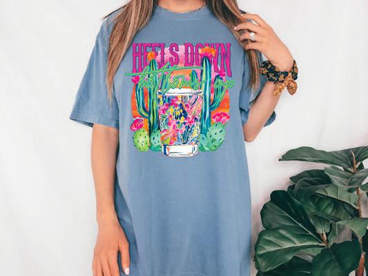 a woman wearing a blue t - shirt with a cactus print