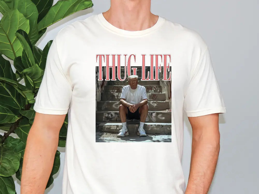 a man wearing a white t - shirt with a picture of a man sitting on