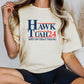 a woman sitting on a chair wearing a hawk utah t - shirt