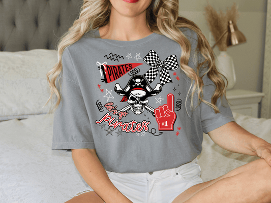 A woman wearing a gray t-shirt with a pirate-themed design, including a pirate hat, skull, and a number one finger.