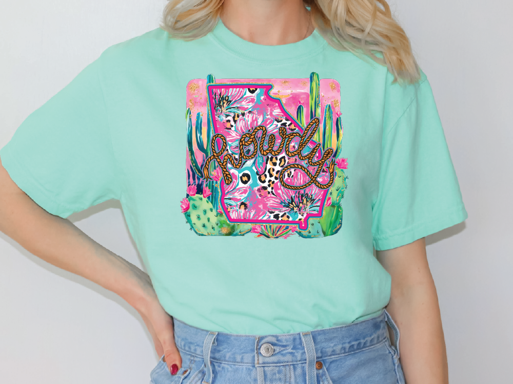a woman wearing a green t - shirt with a picture of a snake on it
