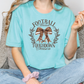 a woman sitting on a couch wearing a t - shirt with a bow on it