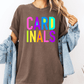 A person wearing a brown t-shirt with the word "CARD" in colorful letters and a denim jacket.