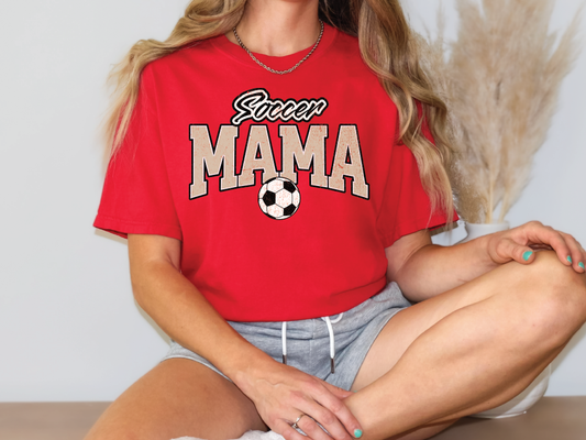 a woman sitting on a table with a soccer ball
