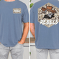 a man wearing a blue t-shirt with a graphic design on the back. The design features a cartoon character wearing a cowboy hat and the word "REBELS" written above it.
