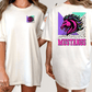 A white t-shirt with a graphic design on the back, featuring a stylized horse's head in pink and purple colors, along with the word "Mustangs" written in pink and purple text.