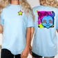 two women wearing light blue t-shirts with colorful designs on the back.