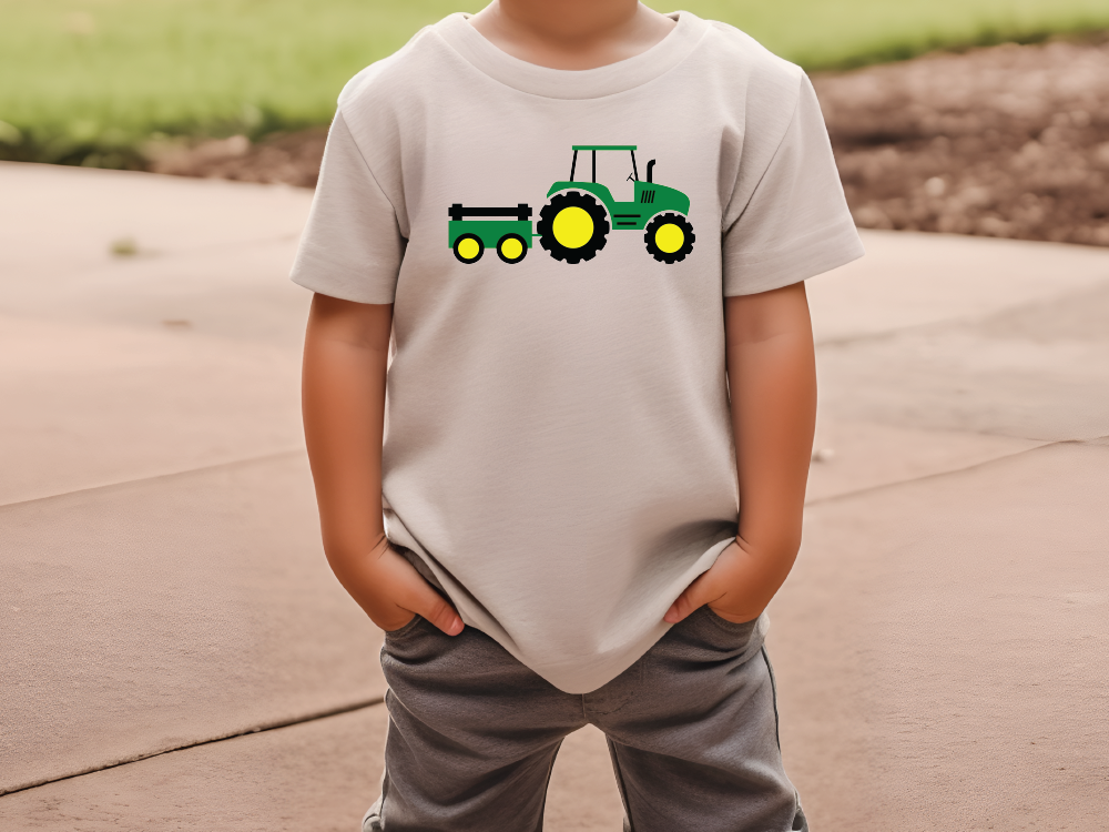 a young boy wearing a t - shirt with a tractor on it