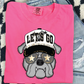 A pink t-shirt with a graphic of a dog wearing sunglasses and a hat with the text "LET'S GO" printed on it.