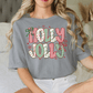 A woman wearing a gray t-shirt with the text "HOLY JOLT" printed on it.