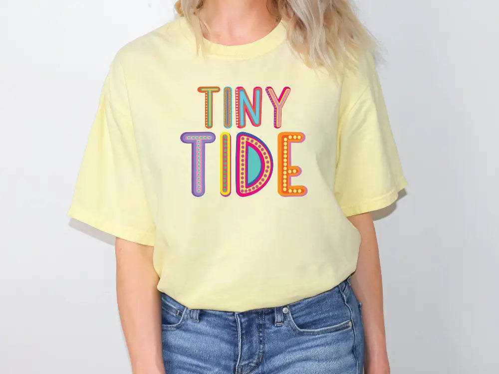 a woman wearing a yellow tiny tide t - shirt