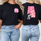 two women wearing black shirts with pink letters on them