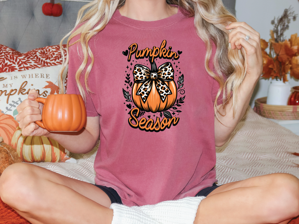 a woman sitting on a bed holding a pumpkin