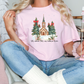 a woman sitting on a couch holding a pink t - shirt