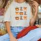 a woman sitting on a couch wearing a t - shirt with pumpkins on it