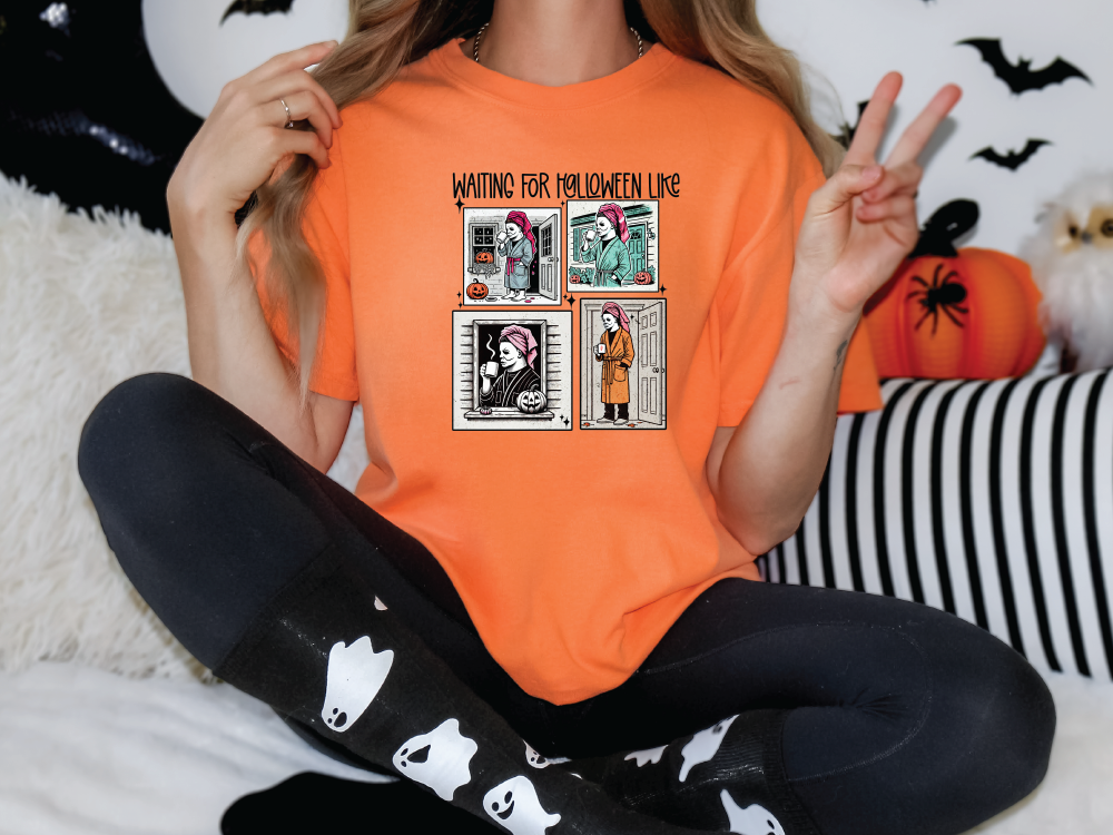 a woman sitting on a bed wearing an orange shirt