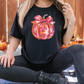 a woman sitting on the ground in front of pumpkins