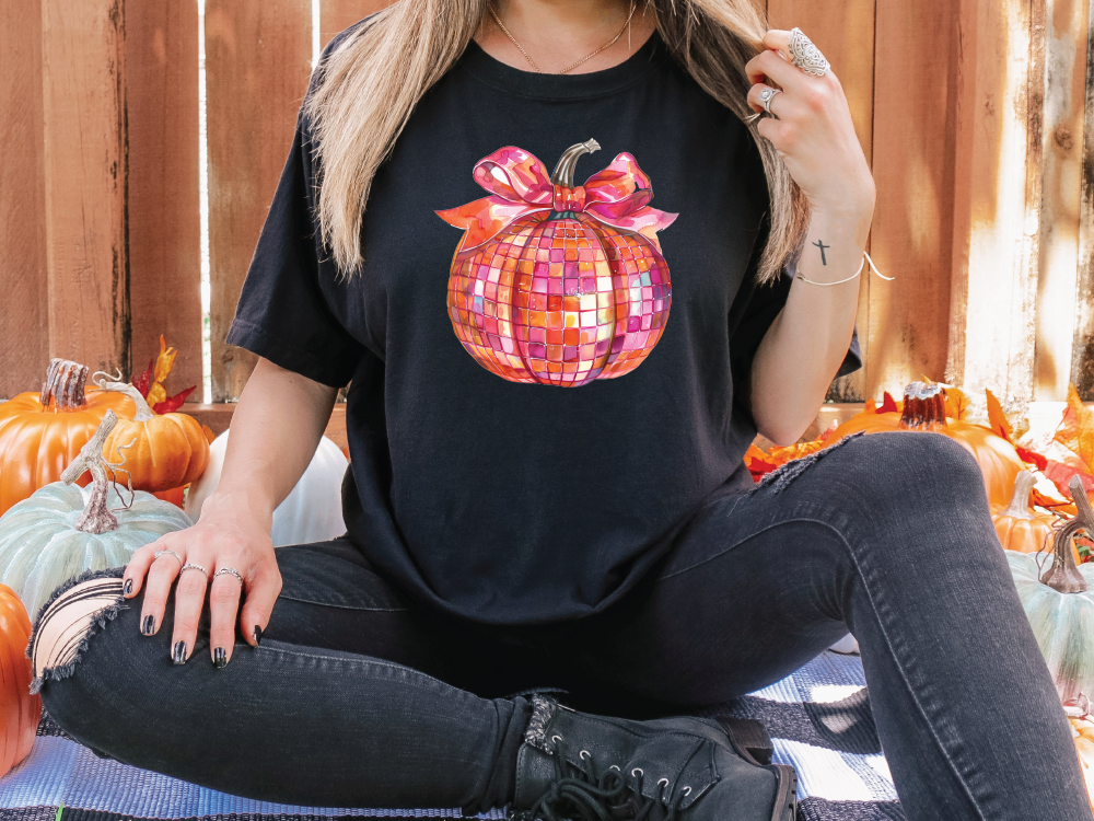 a woman sitting on the ground in front of pumpkins