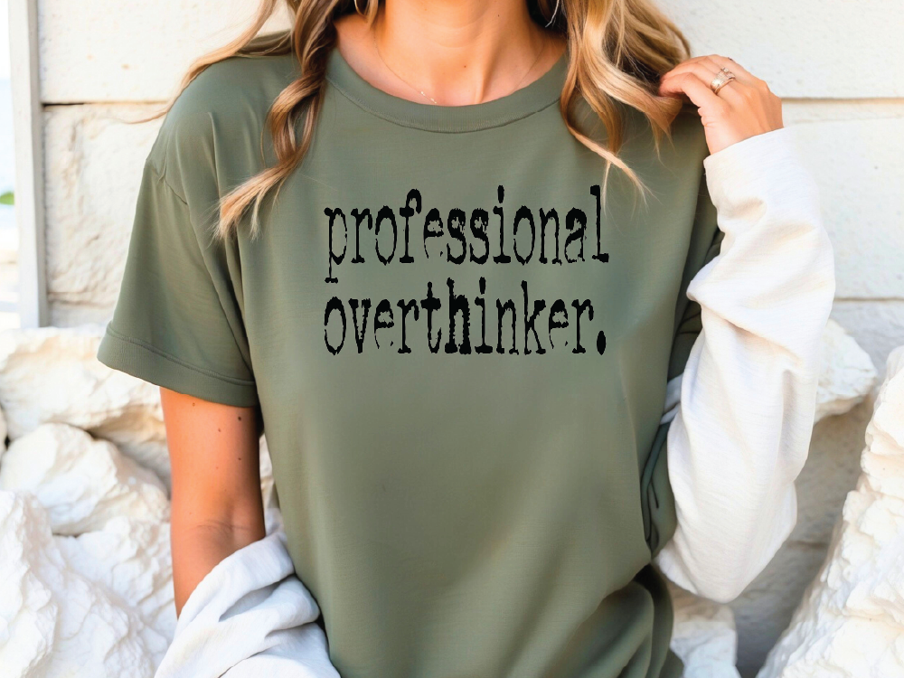 a woman wearing a green shirt that says professional overthiker