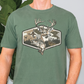 A green t-shirt with a graphic design depicting a deer, a bird, and a fish.