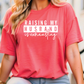 a woman wearing a red shirt that says raising my husband is fascinating