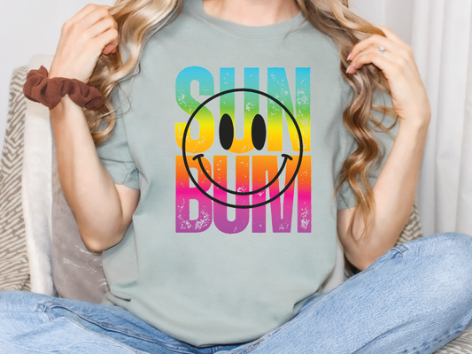 a woman sitting on a couch holding a t - shirt with a smiley face on