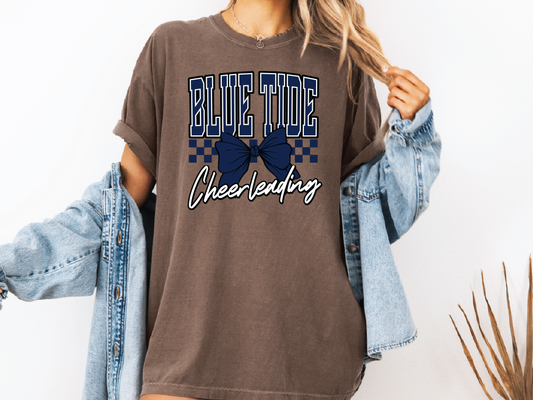 a woman wearing a brown tshirt with a blue ribbon on it